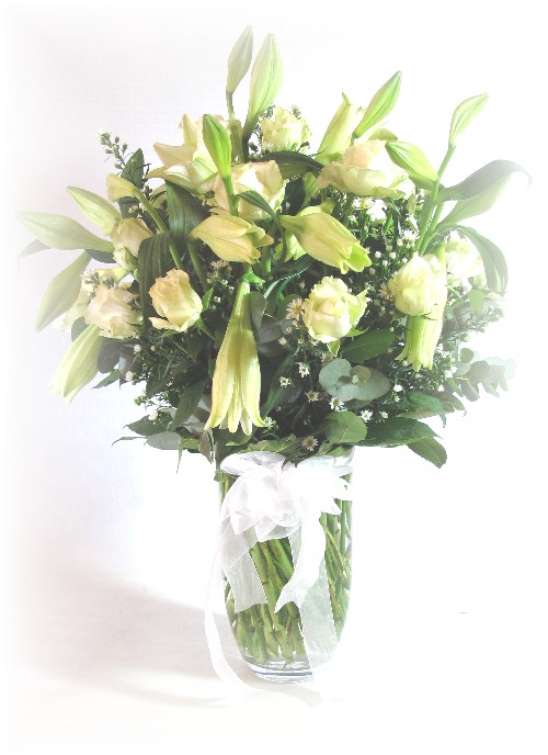 selection of white seasonal flowers in clear vase