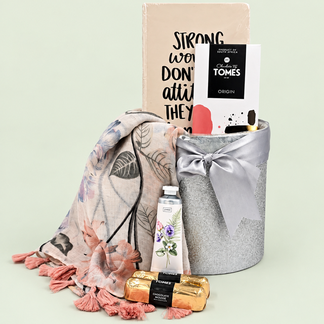 Strong Women gift hamper with a floral scarf, notebook, hand cream and Tomes chocolates in a silver container with a bow