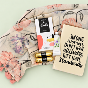 Strong Women gift hamper with a floral scarf, notebook, hand cream and Tomes chocolates in a silver container with a bow