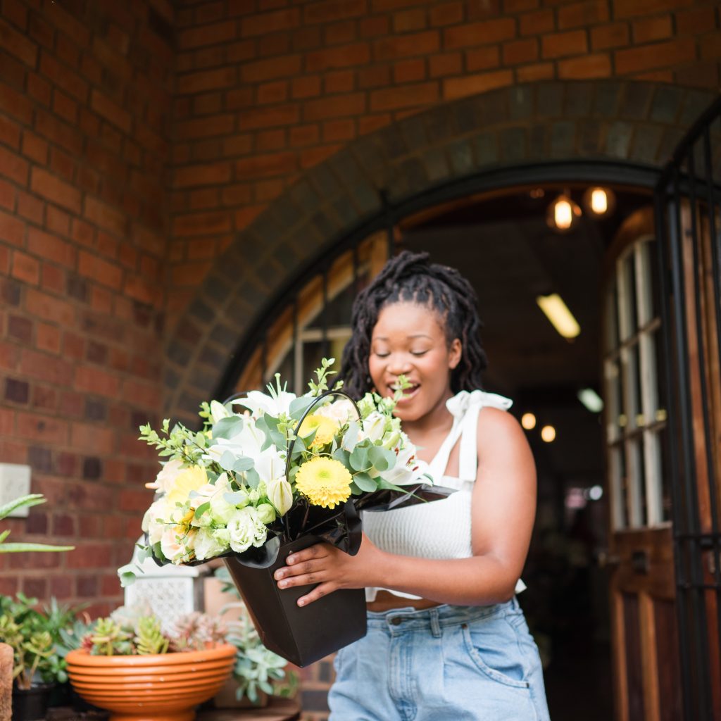 Recipient excited to receive a flower surprise from a loved one.