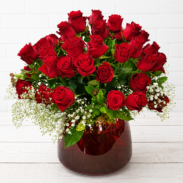 Premium Red Roses in a Ruby Glass Vase | Flower Delivery Pretoria | Eros Florist Send premium red roses beautifully arranged in a ruby glass vase. Handcrafted by Eros Florist with same-day flower delivery across Pretoria for every special occasion.