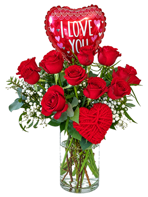A dozen red roses in a glass vase with an I Love You balloon and decorative red heart