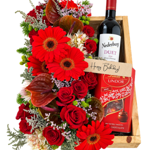 Classic red flower arrangement with chocolates and red wine in a wooden gift tray