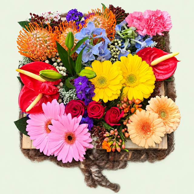 Order Splash of Colour from Eros Florist. A bright seasonal flower arrangement in a wooden tray, made fresh for delivery in Pretoria.