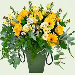 Yellow and cream seasonal flowers in a moss green box with black satin ribbon handles
